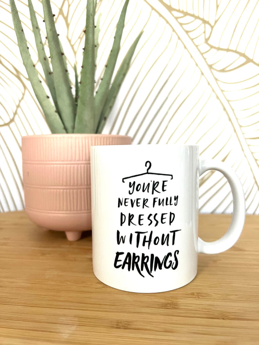 Youre never fully dressed without earrings mug